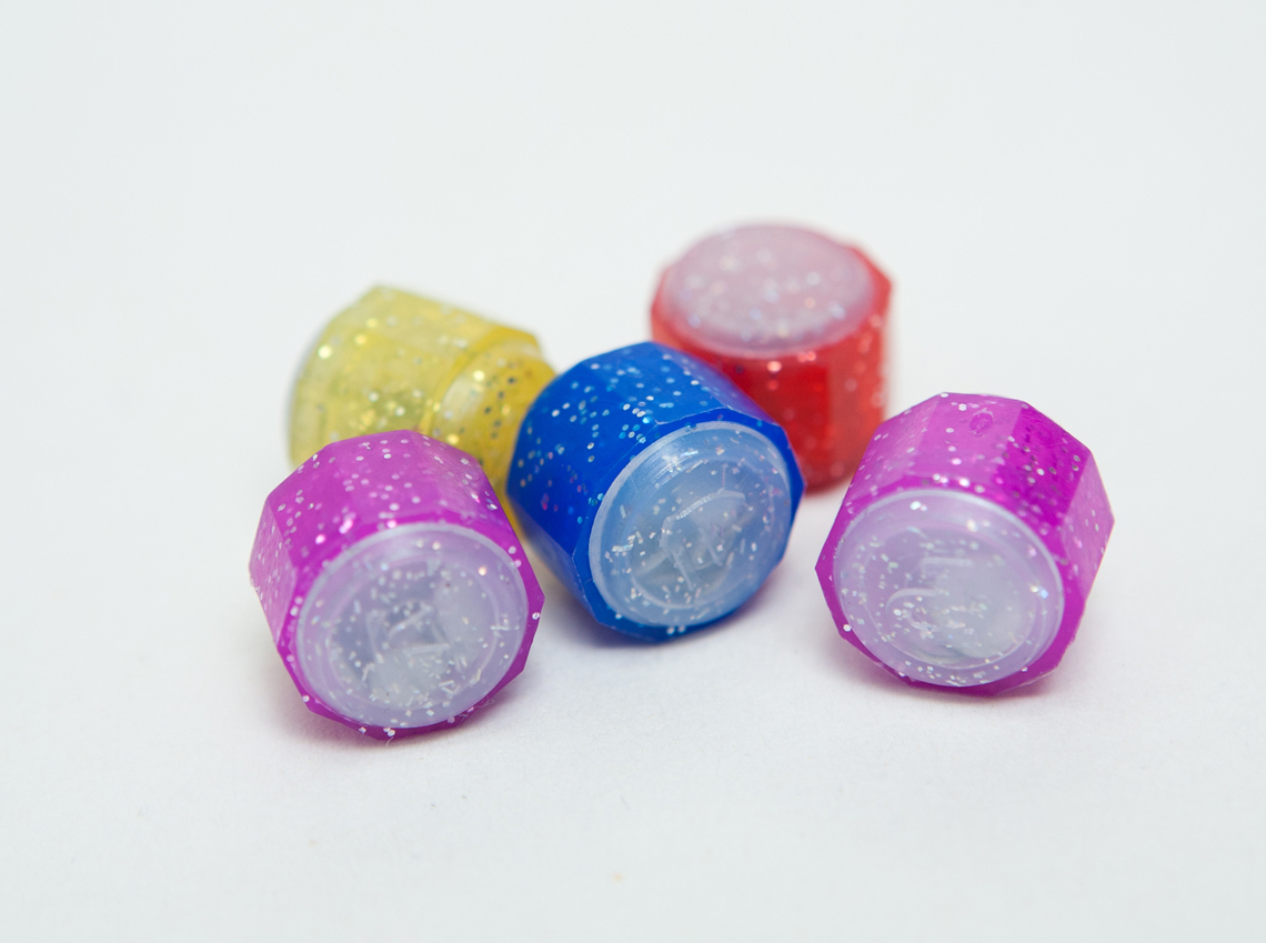 Five colorful plastic gonggi playing stones